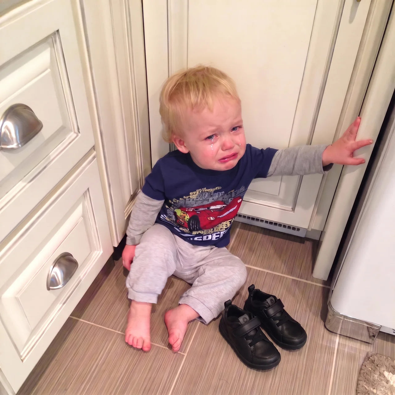 Toddler upset because of uncomfortable shoes